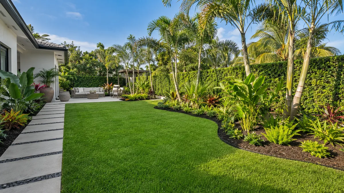 Manicured lawn and tropical landscape design by TRIMZ